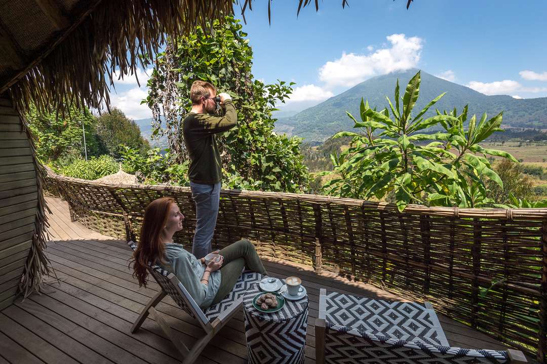 Bisate Lodge guests looking out over the mountains from their room