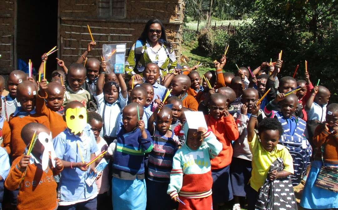 Aline Umutoni pictured with local school children